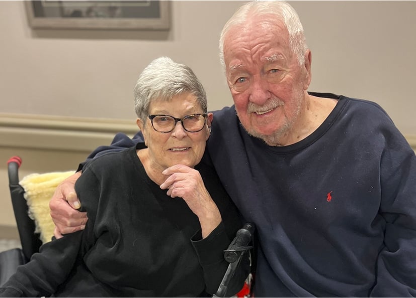two seniors hugging