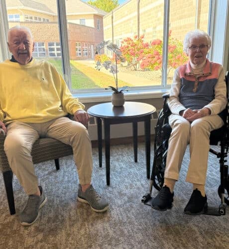 residents sitting together in front of window