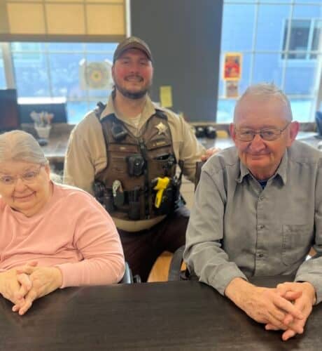 two elders posing with law enforcement man