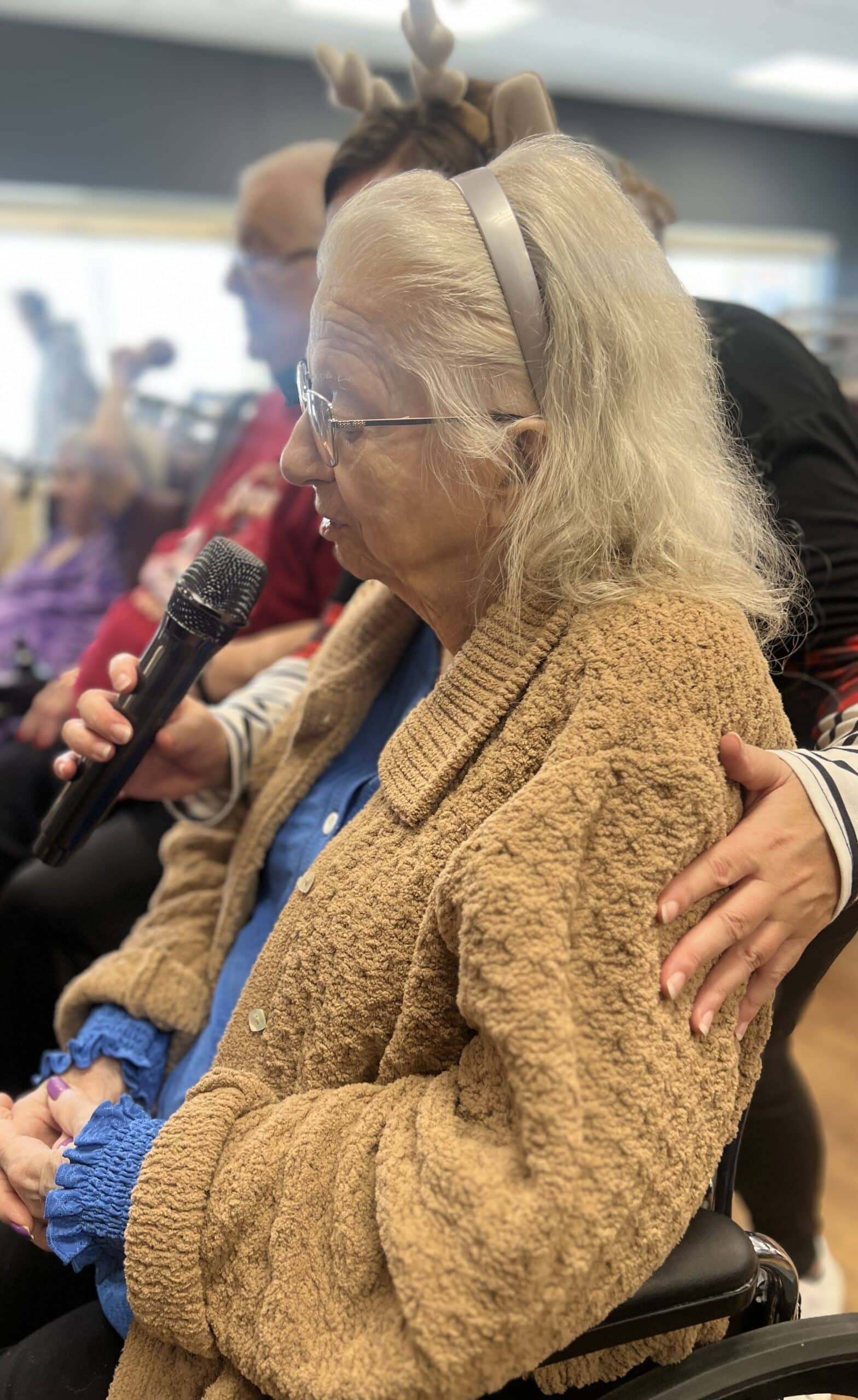 elder speaking into a microphone