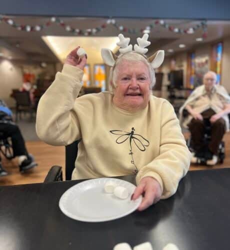 senior throwing marshmallow on a place