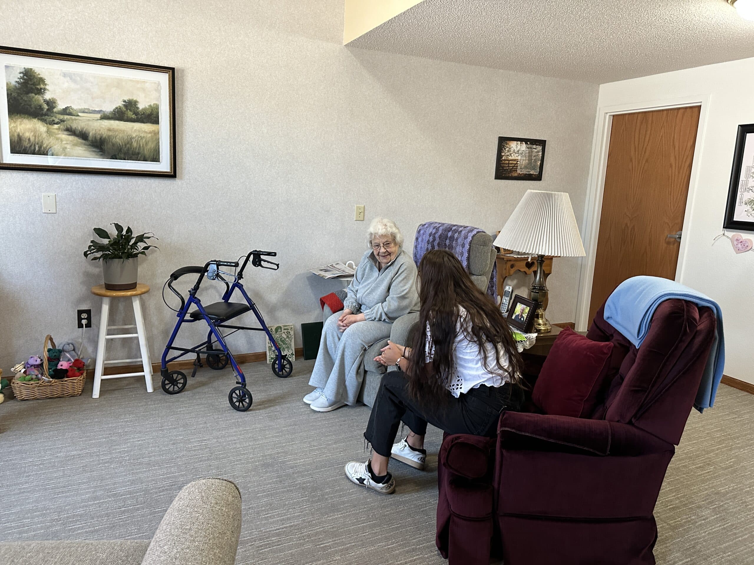 resident chatting with aid in room