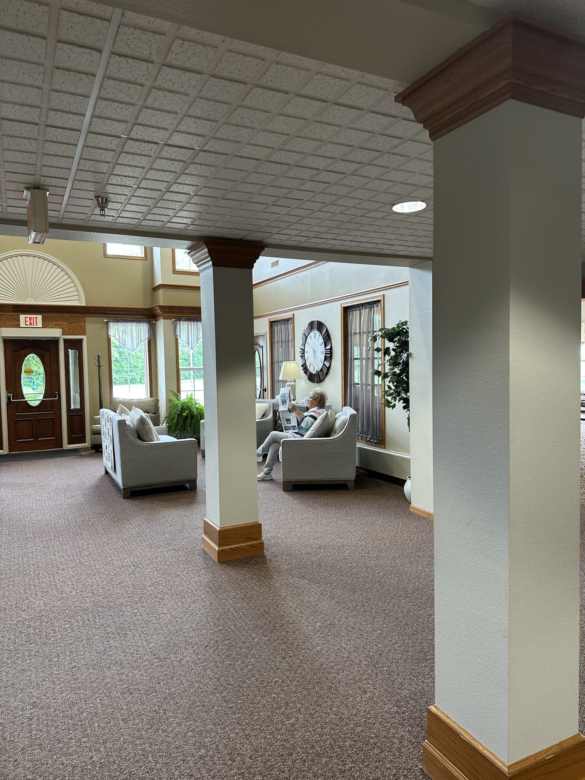 woman sitting on couch in the entry at edgewood gables