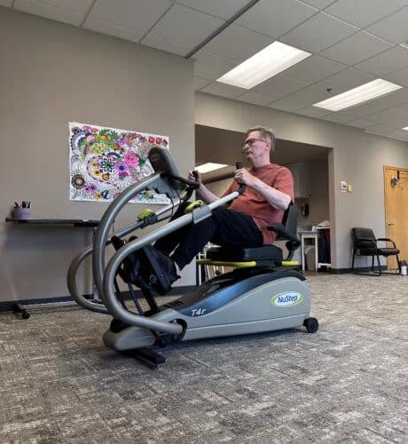 man on excerise bike at rehabilitation facility