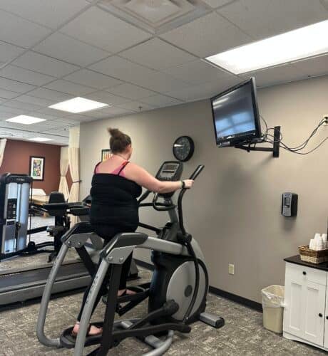 person on treadmill at work at facility