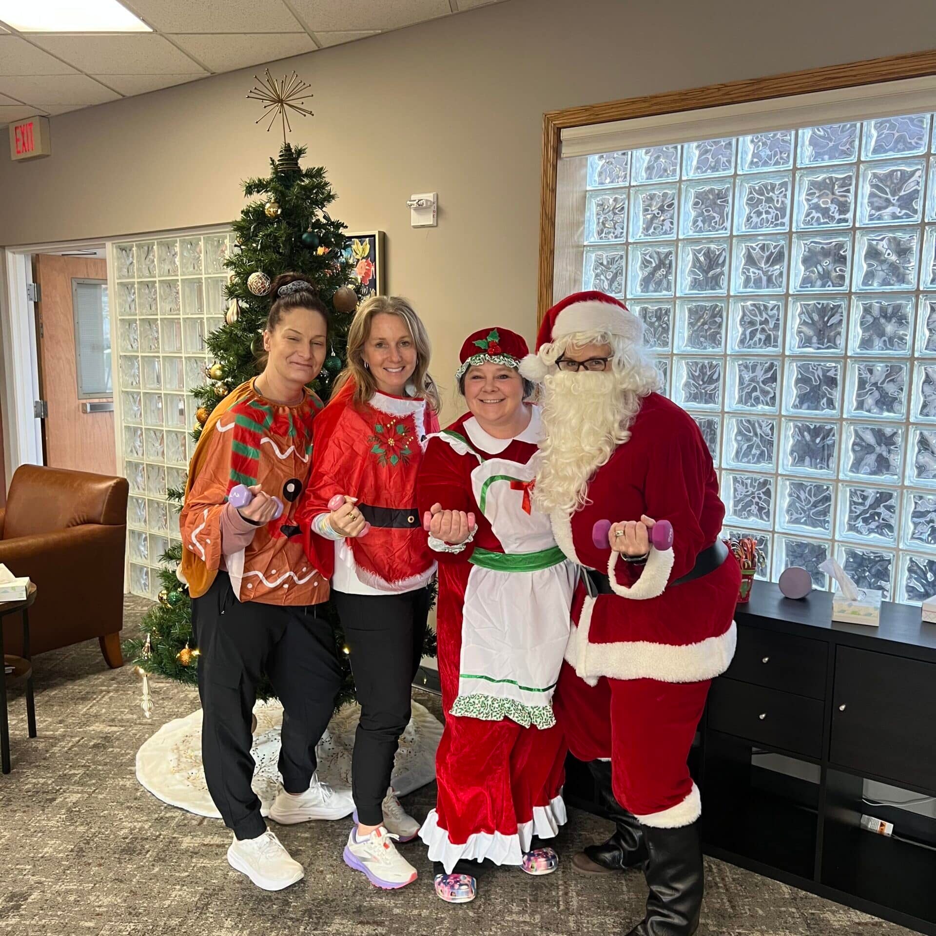 group of women posing with santa clause