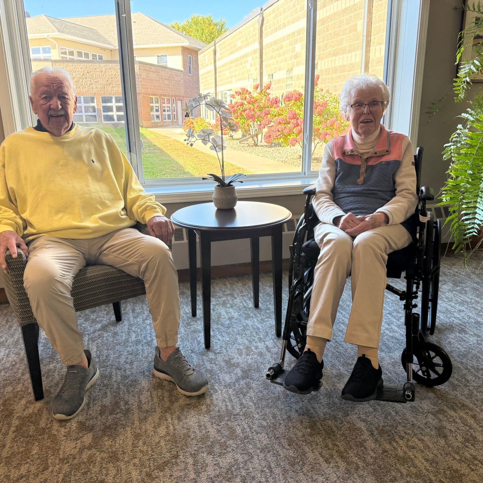 residents sitting together in front of window