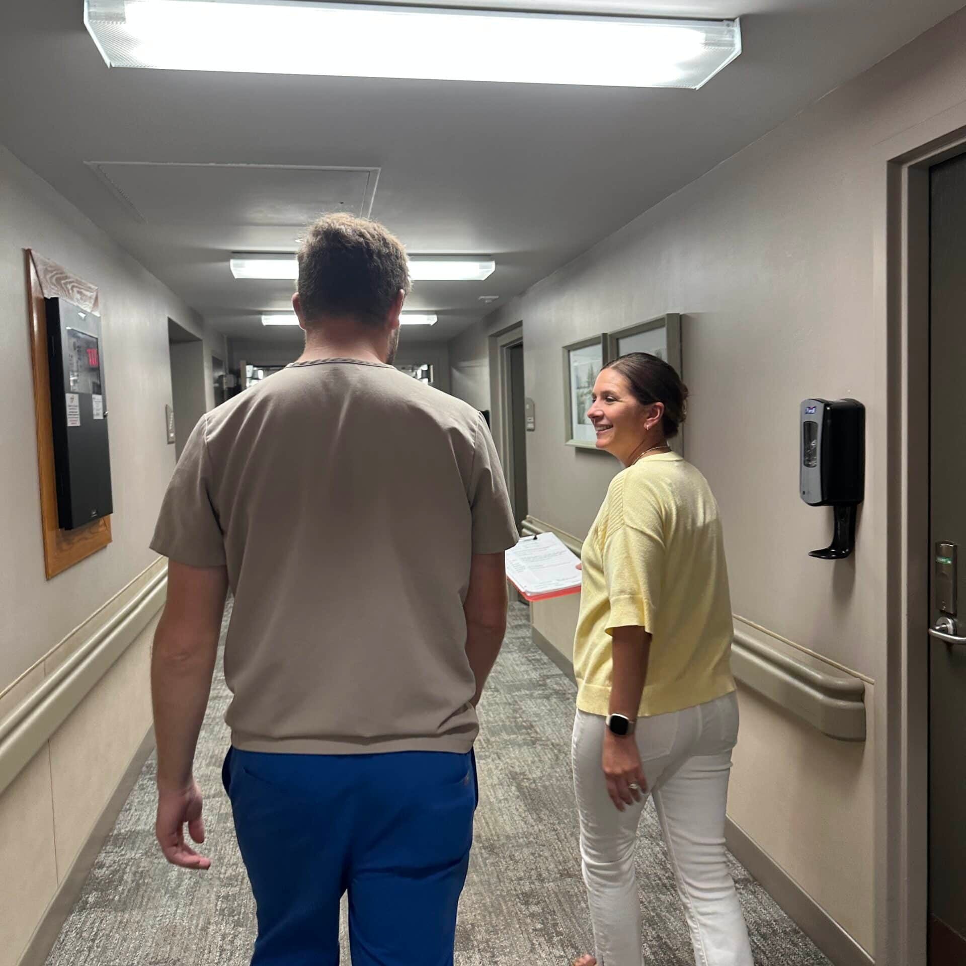 staff walking down hallway at cokato manor